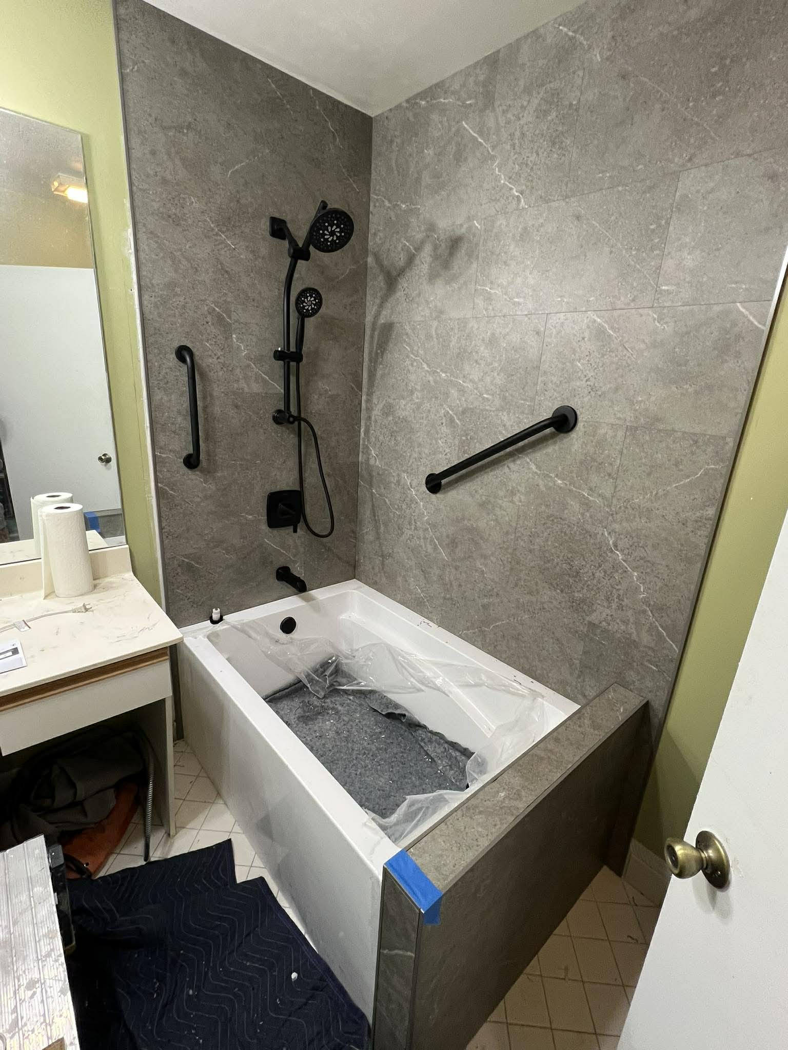 Step 4: Tile work in progress with shower hardware installed during bathroom remodel by Custom Bath and Tile