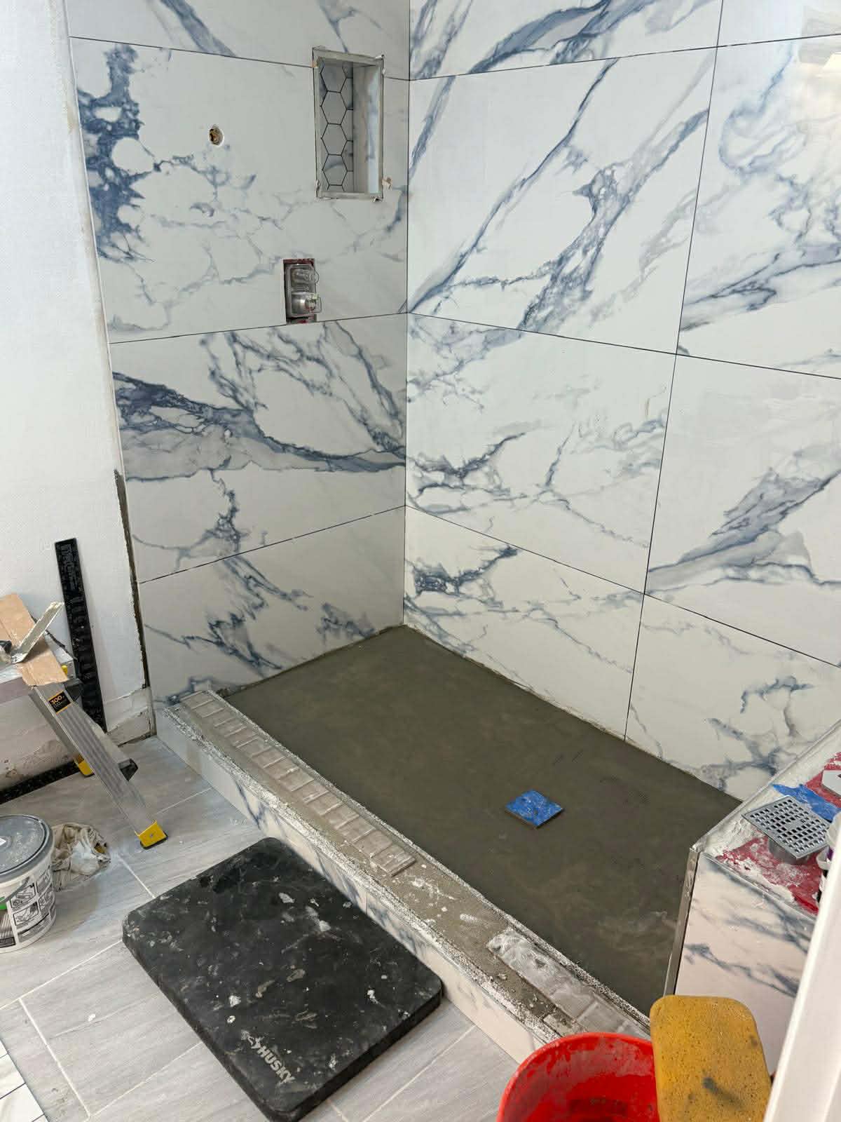 Tile installation in progress with premium marble tile